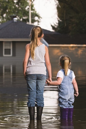 Two little girls standing in a flood
